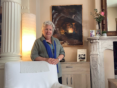 Gaby and her painting at home.